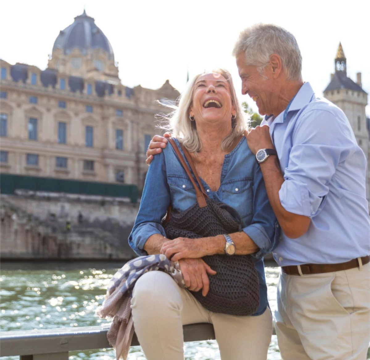 Senior couple laughing together next to a river