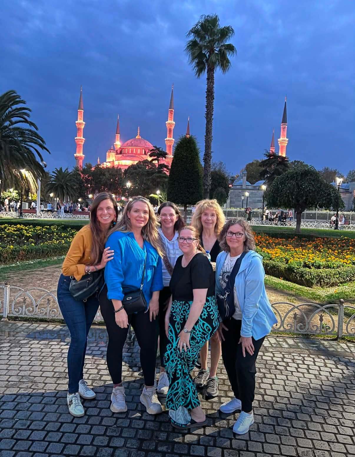 Group of women taking a picture in front of a landmark