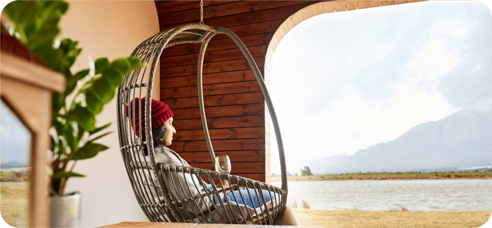 A woman relaxing in a hammock chair taking in a breathtaking view