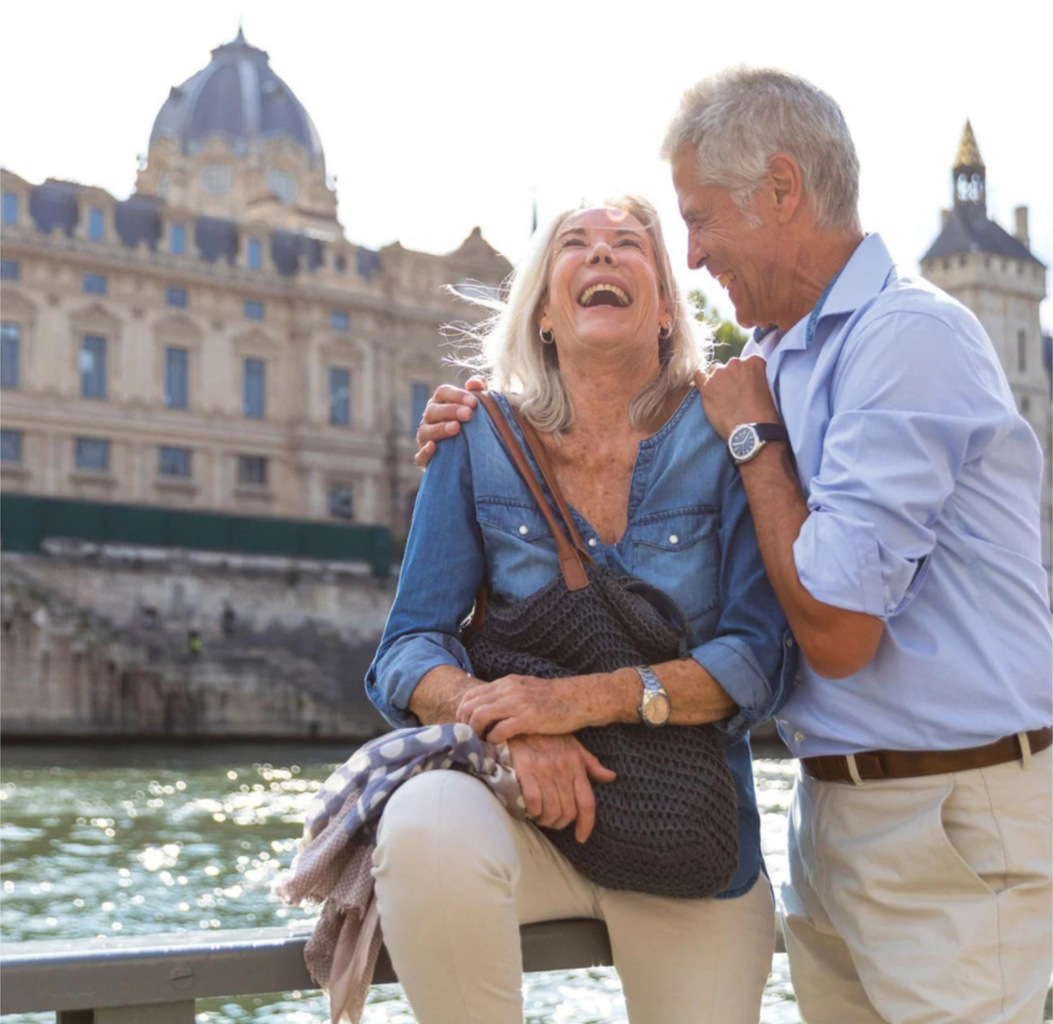 Senior couple laughing together next to a river