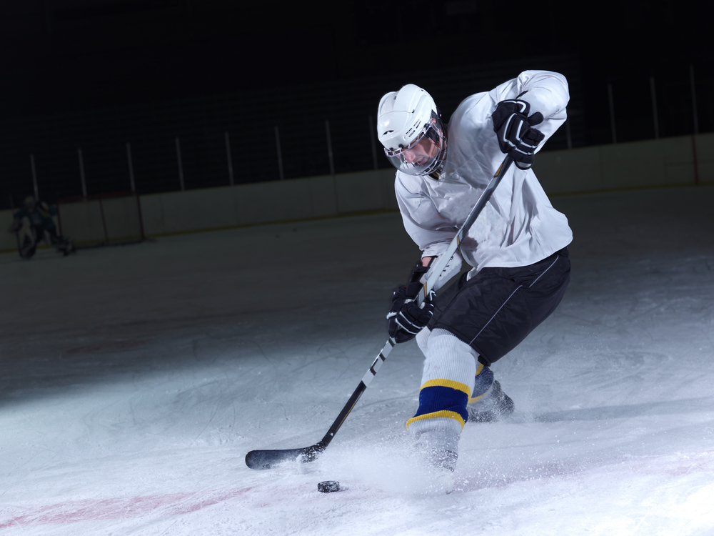 Action shot of hockey player stopping