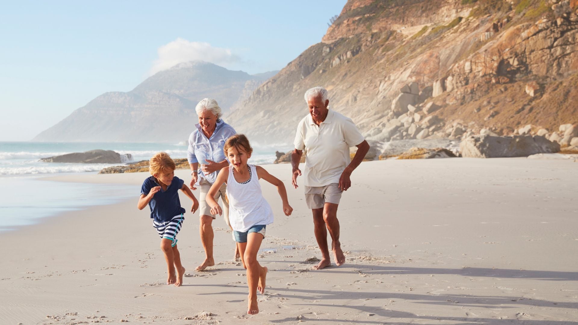 Multigenerational family walking on the beach