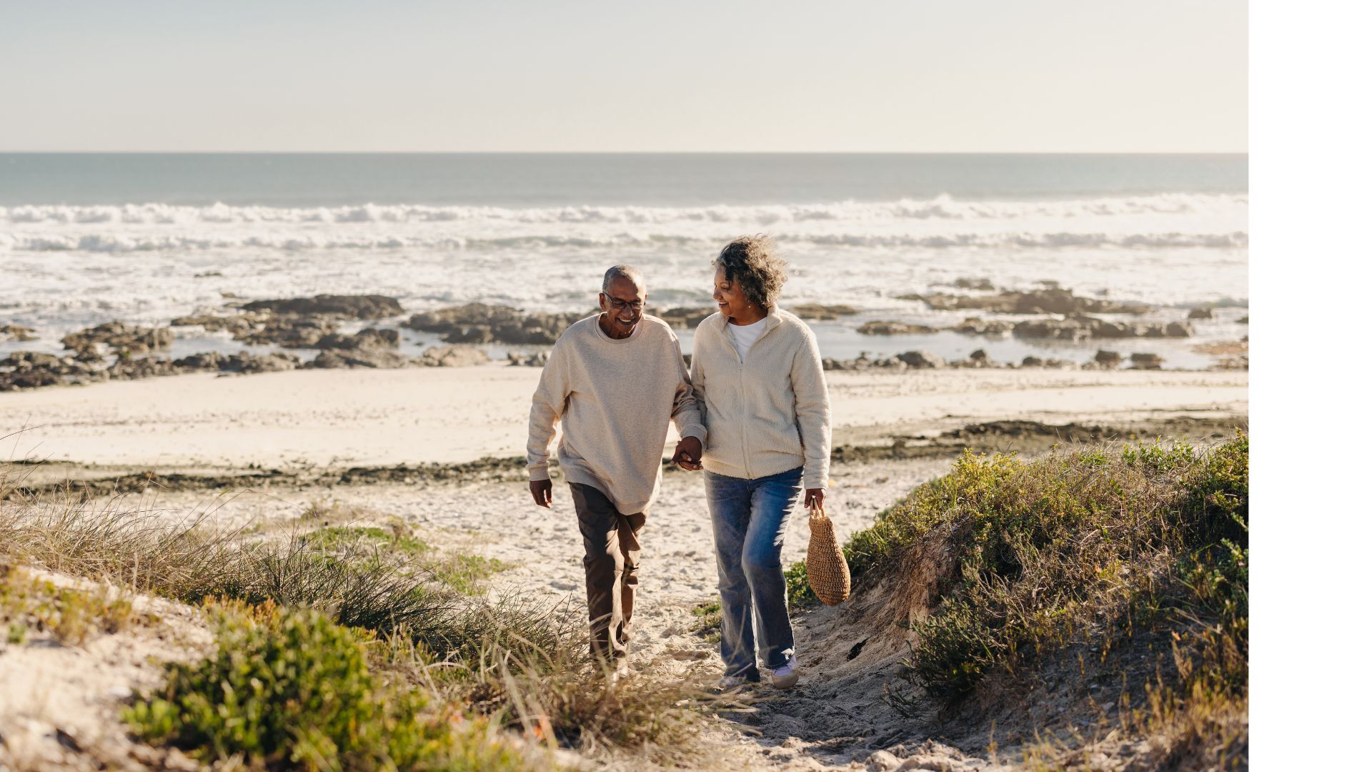 Senior couple taking a evening beach walk
