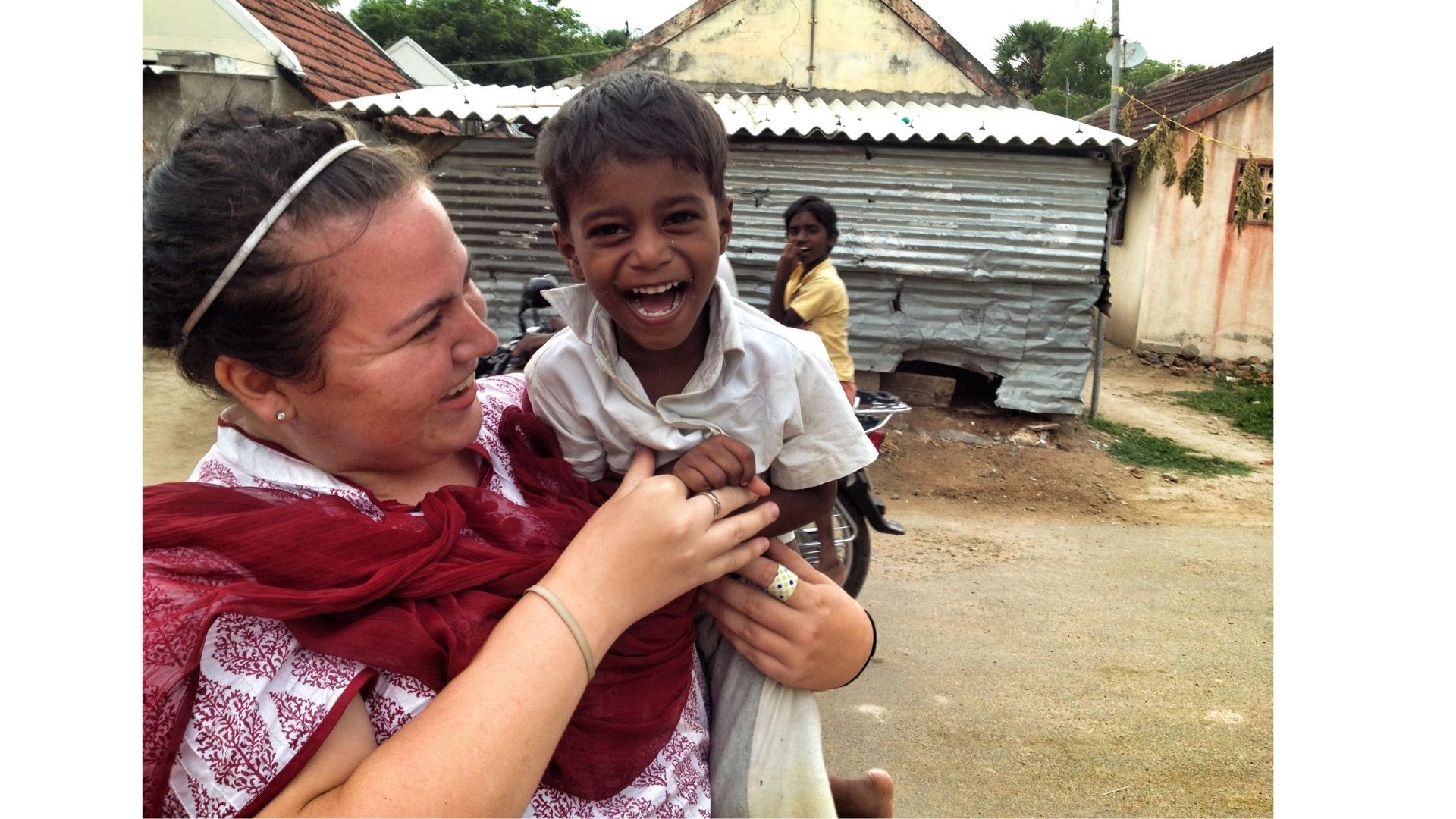 A woman holding a smiling child