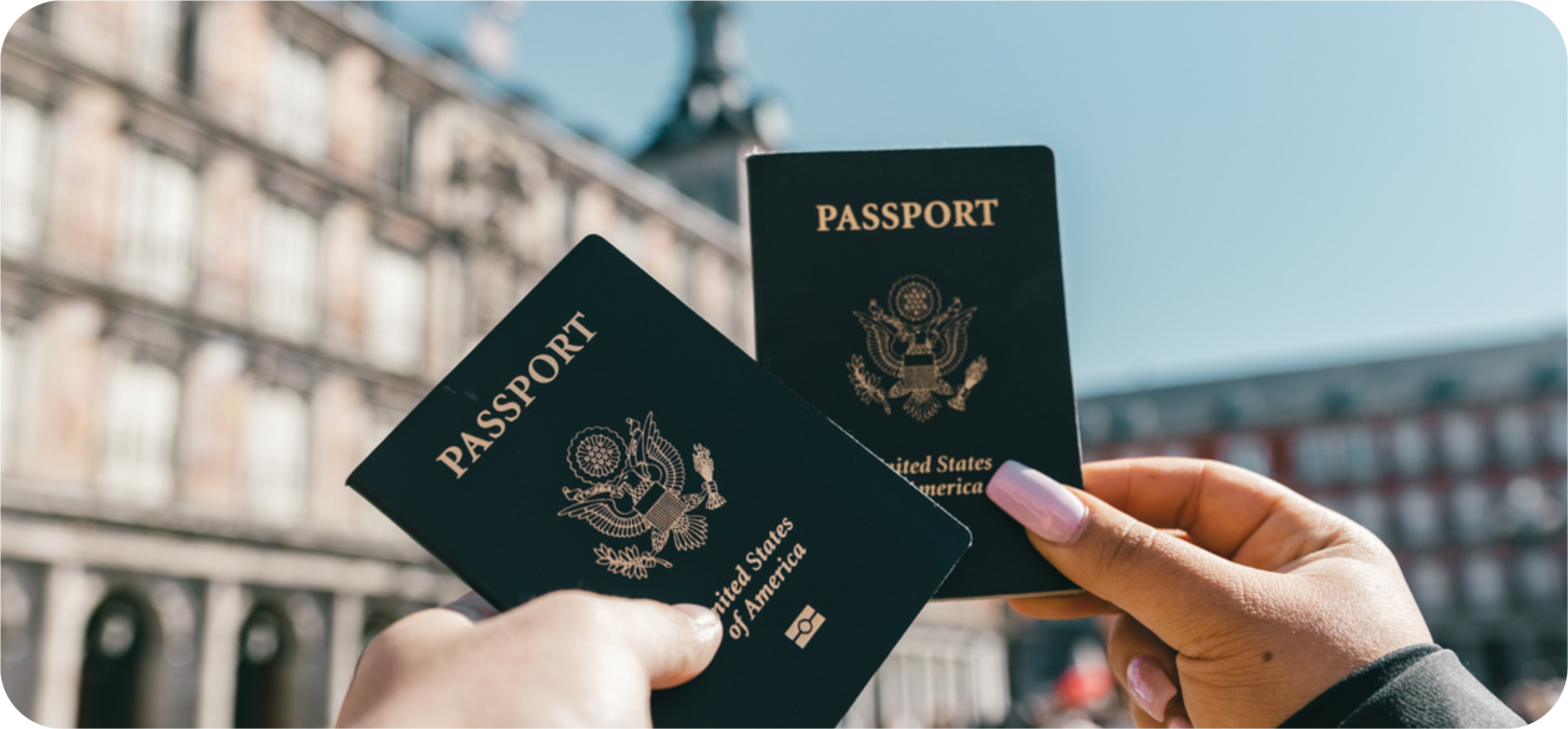 2 travelers holding out their passports