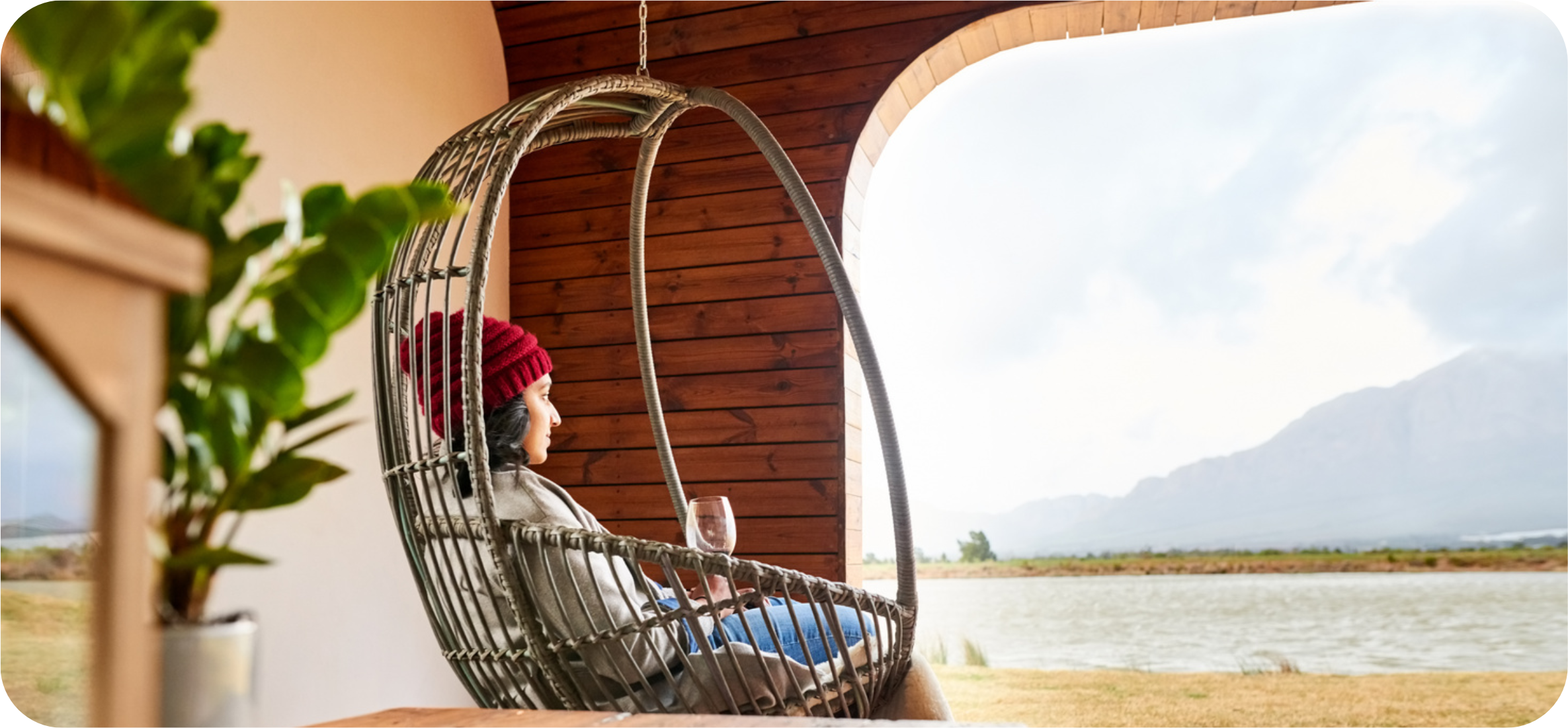 A woman relaxing in a hammock chair taking in a breathtaking view
