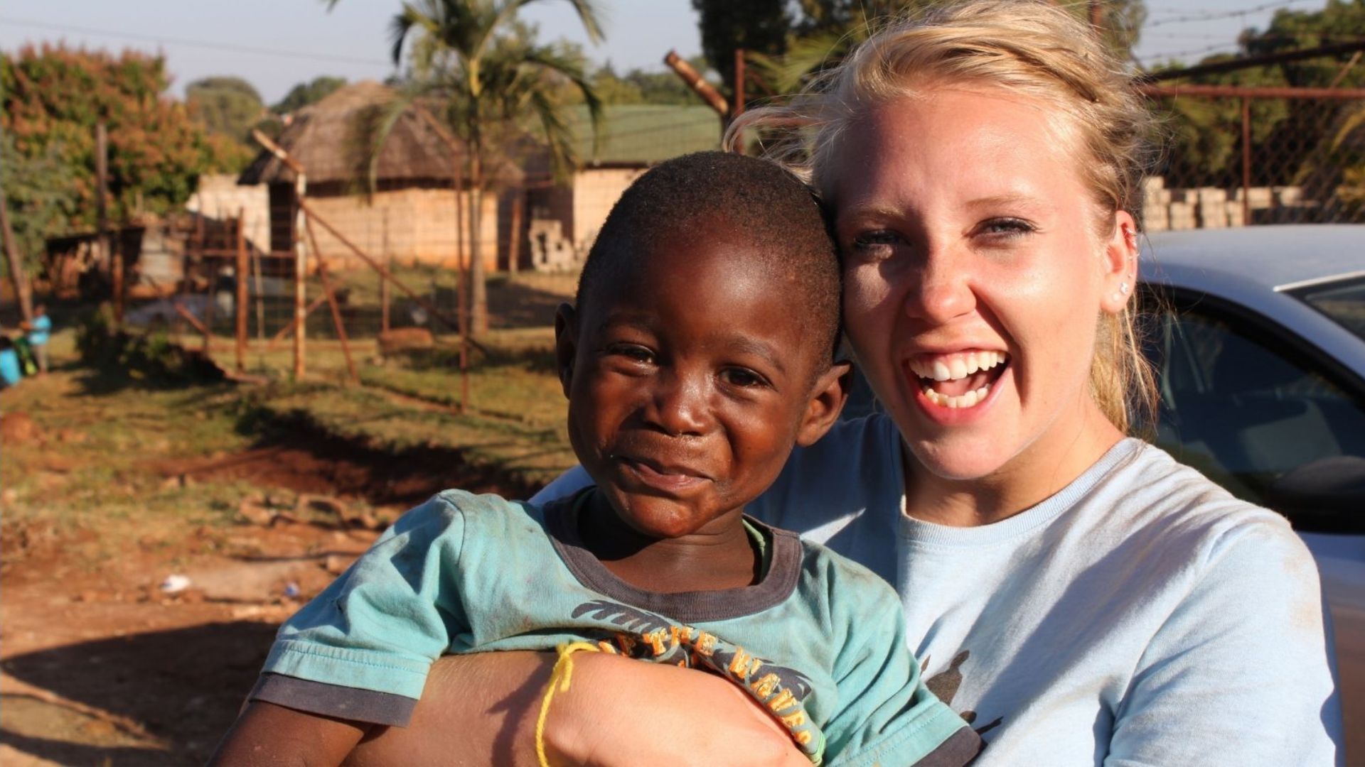 A happy woman seems to be making the child happy